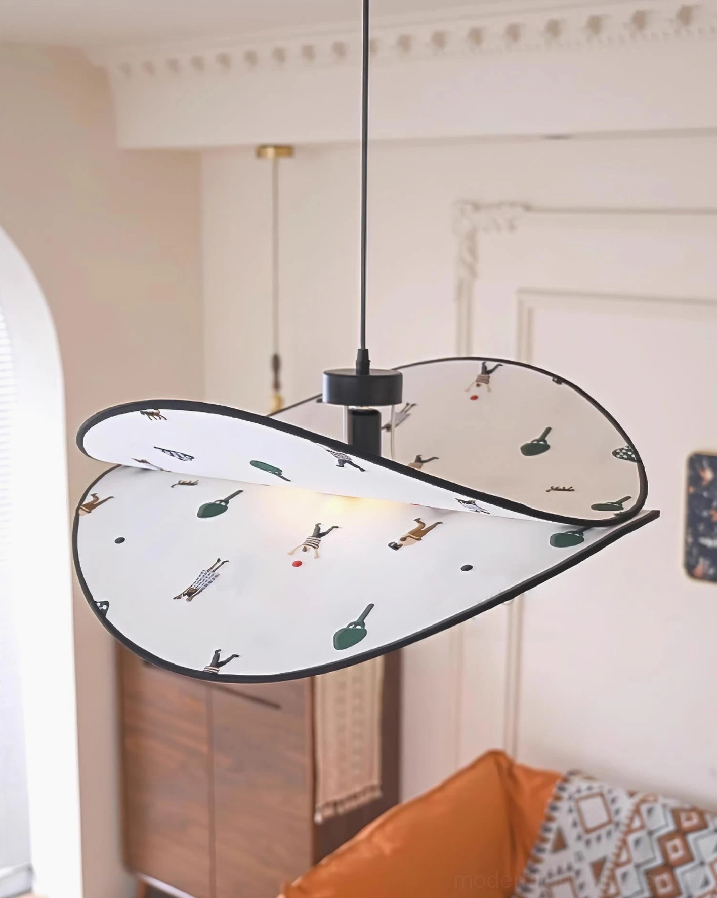 Modern fabric pendant lamp with twisted petal shape and black ceiling mount, contemporary living room with sofa