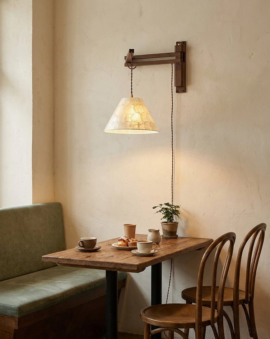 Dining nook wall sconce above small bistro table, warm cafe-style ambient lighting with wood furniture