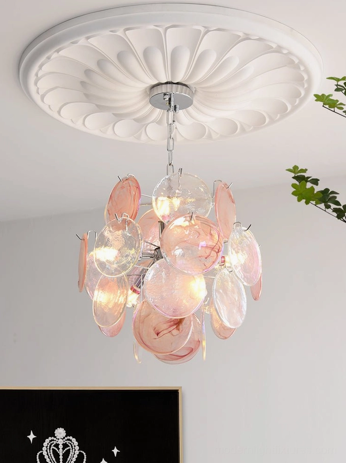 Iridescent glass disc modern chandelier over dining table setup showing functional placement