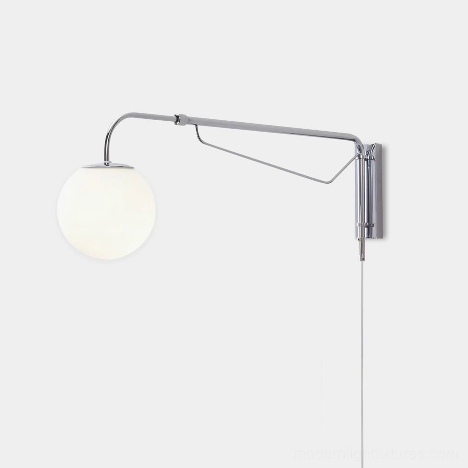 Dione adjustable swing arm wall sconce with chrome metal arm and frosted acrylic globe shade, side angle close-up detail view