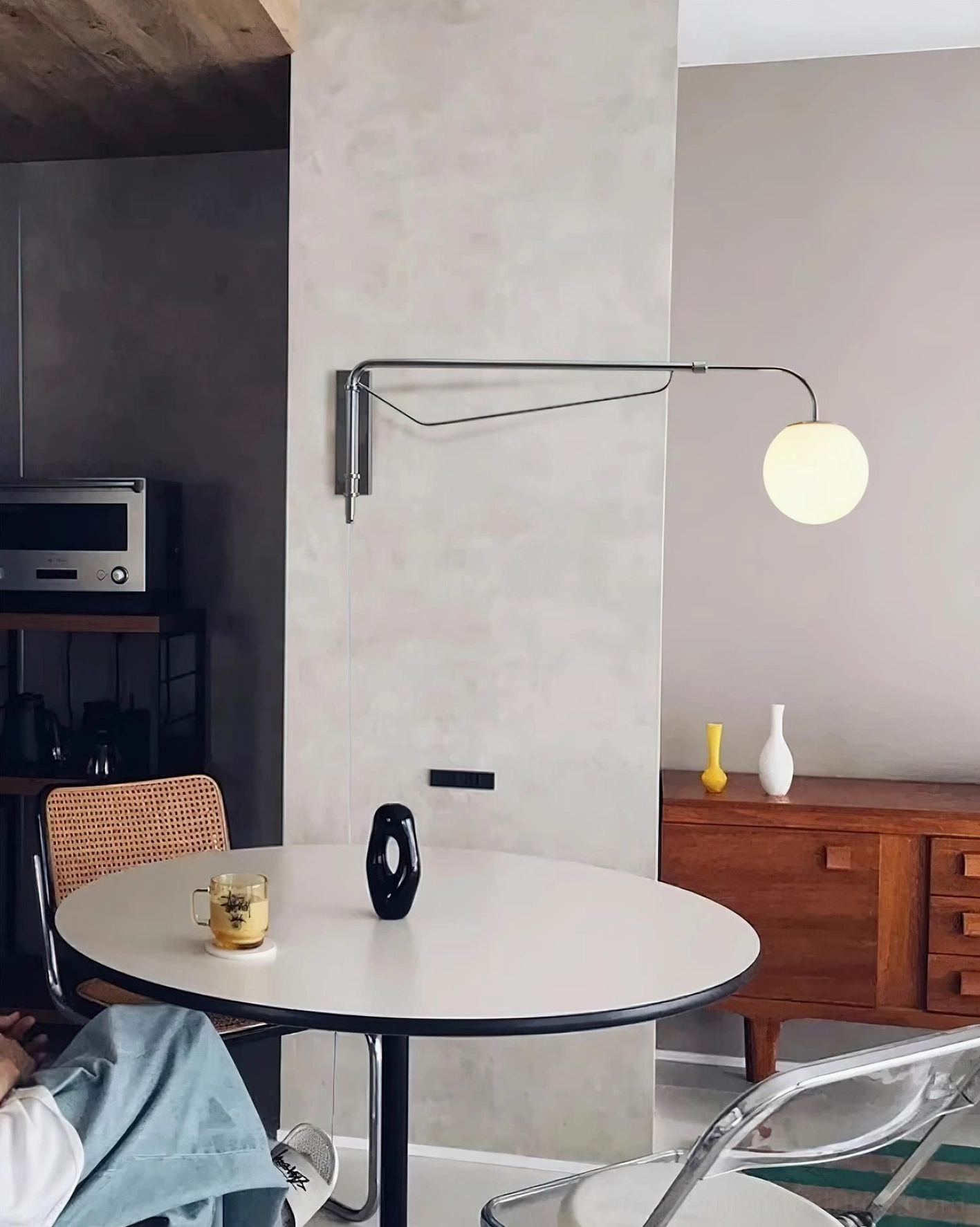 Dione adjustable wall sconce installed in modern dining nook mid-century minimalist interior design