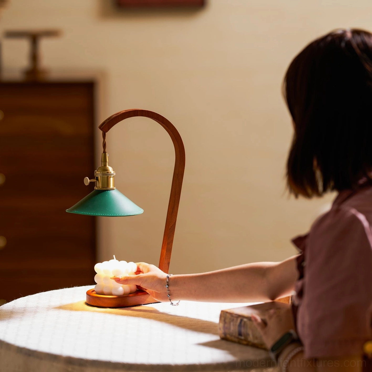 Diosa candle warmer table lamp being adjusted with retro wood brass green color scheme home