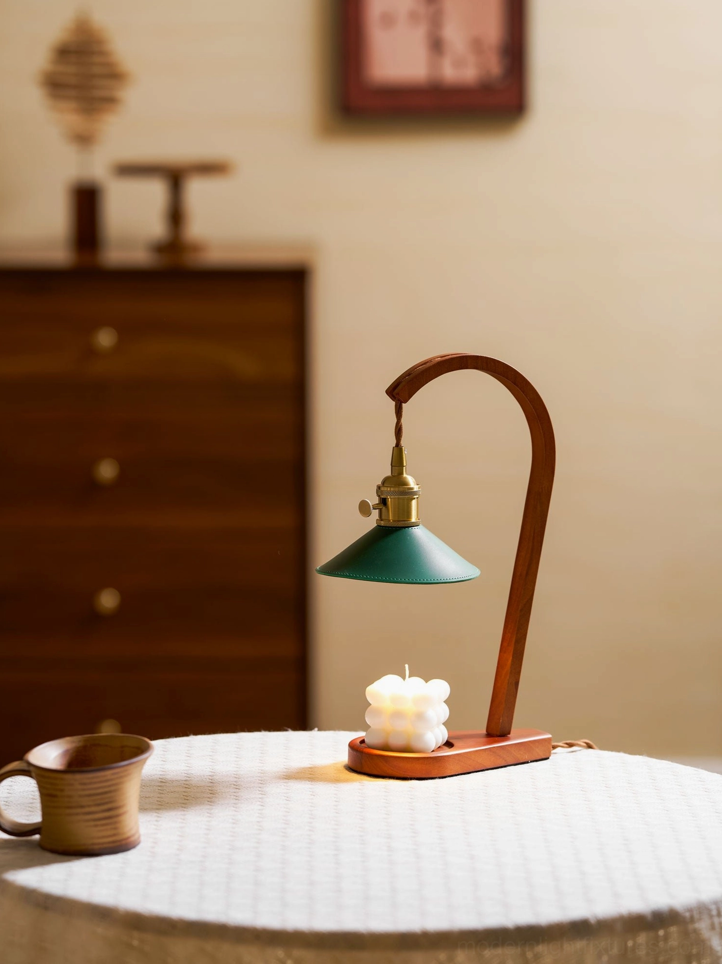 Diosa candle warmer table lamp on round linen table with decorative candle and neutral decor