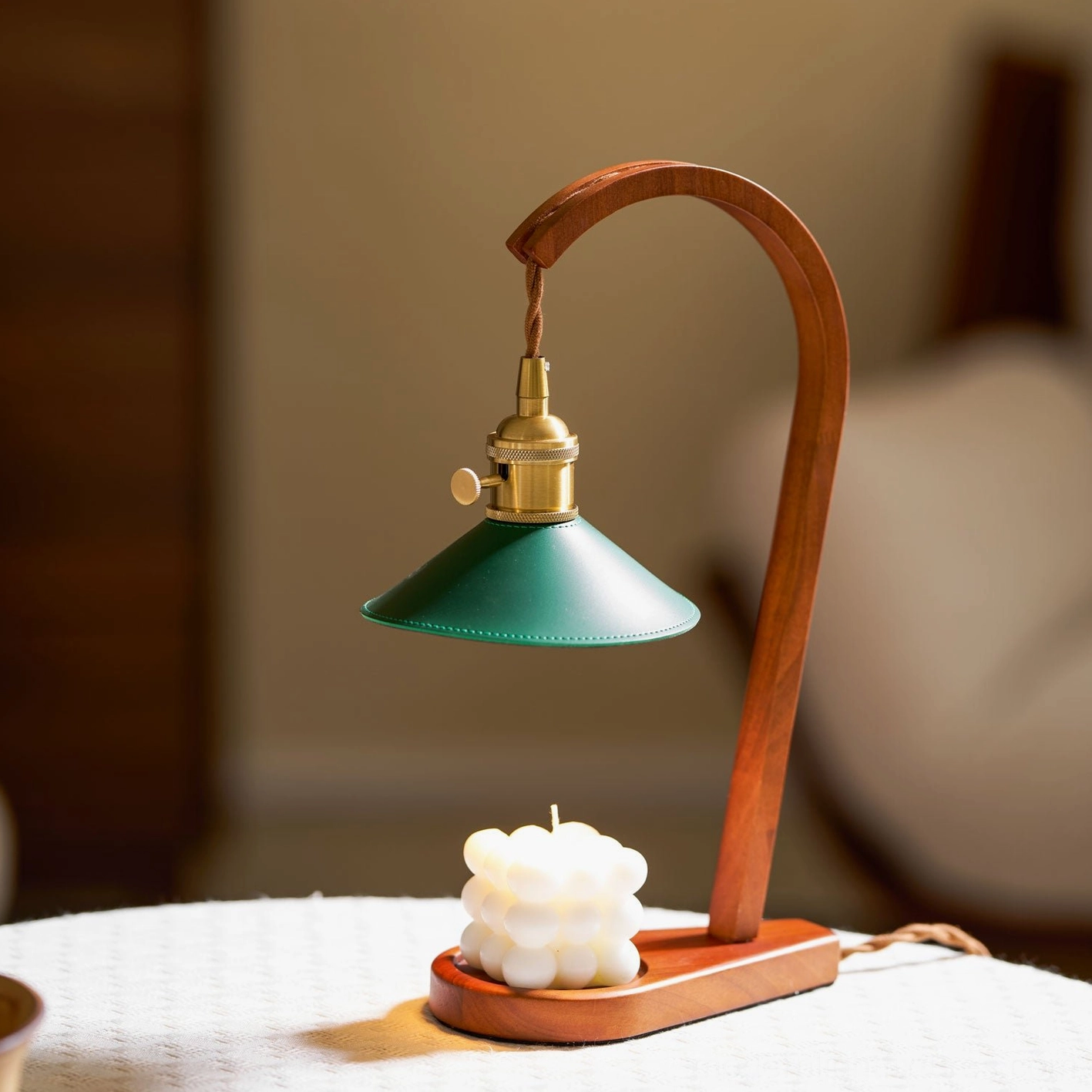 Diosa candle warmer table lamp front angle with large scented candle and soft interior lighting
