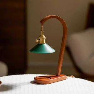 Diosa candle warmer lamp three-quarter view with brass switch and curved wood arm on side table
