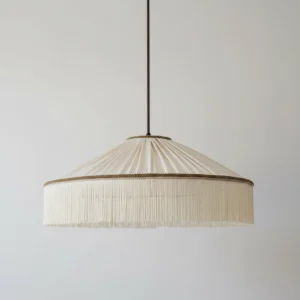 Diosa fabric pendant light side angle view showing pleated shade structure and full fringe tassel edge detail in minimalist boho style