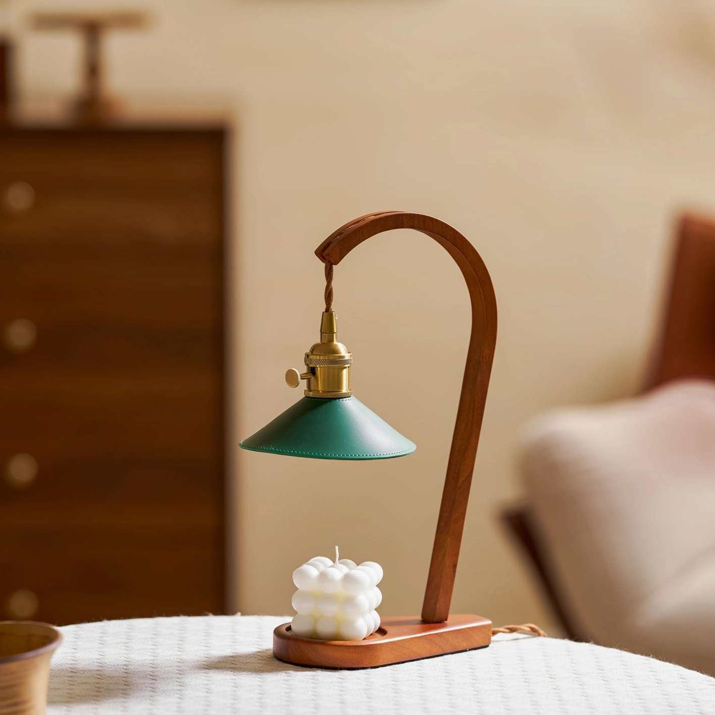 Diosa wood candle warmer lamp with brass socket and sculpted candle on living room table