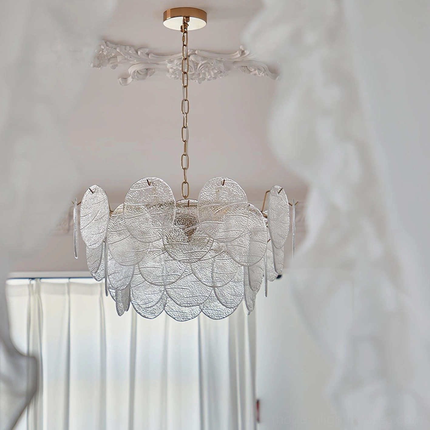 Victorian disc glass chandelier hanging in French style bedroom with sheer curtains