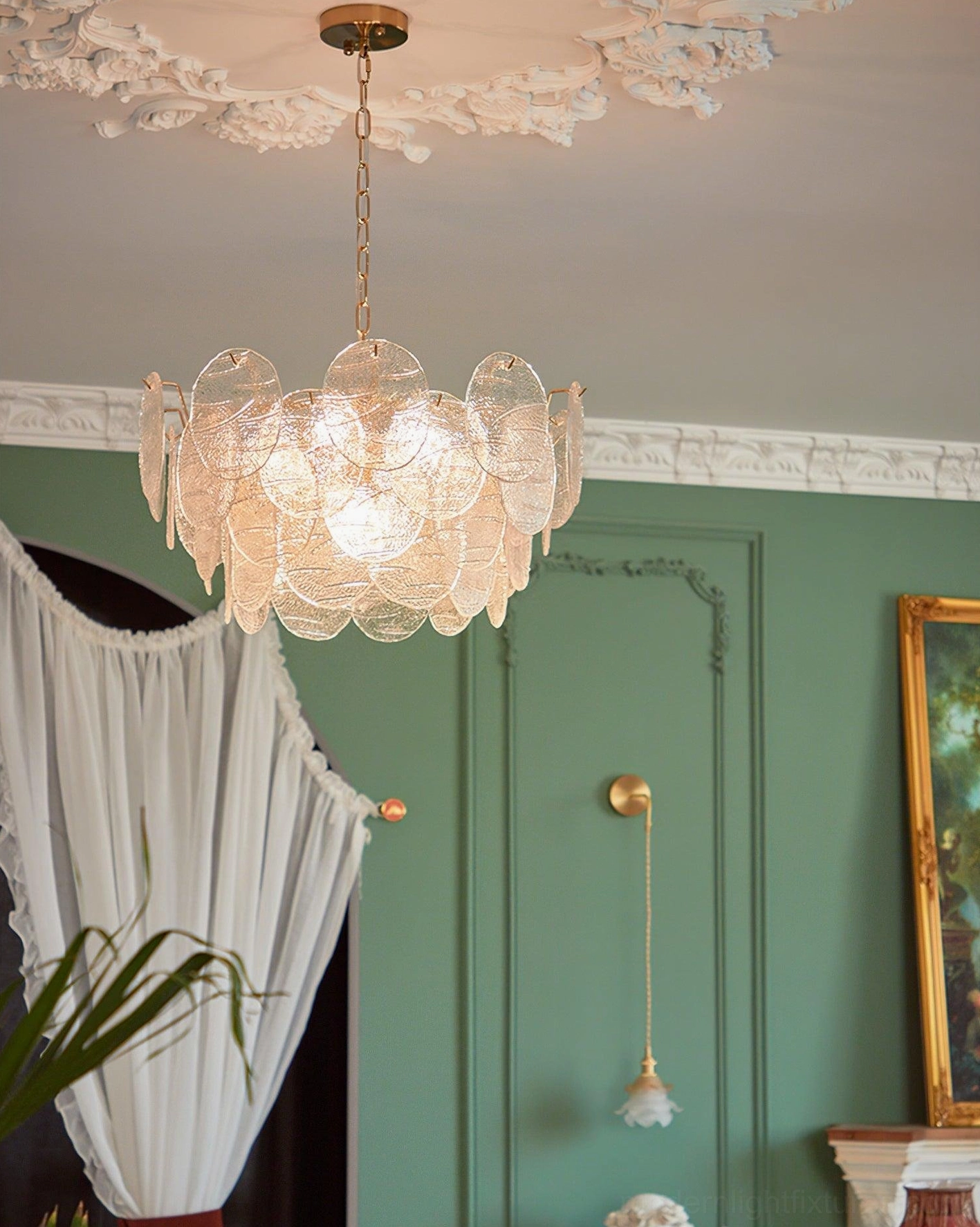 Gold disc Victorian chandelier illuminated showing warm light diffusion through clear glass