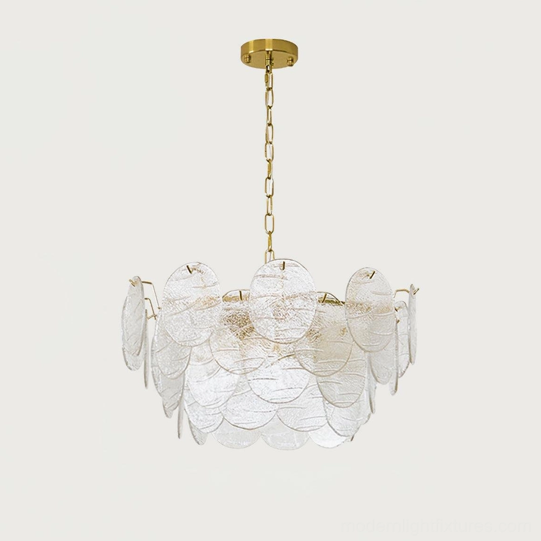 Gold disc Victorian glass chandelier above dining table in transitional interior design