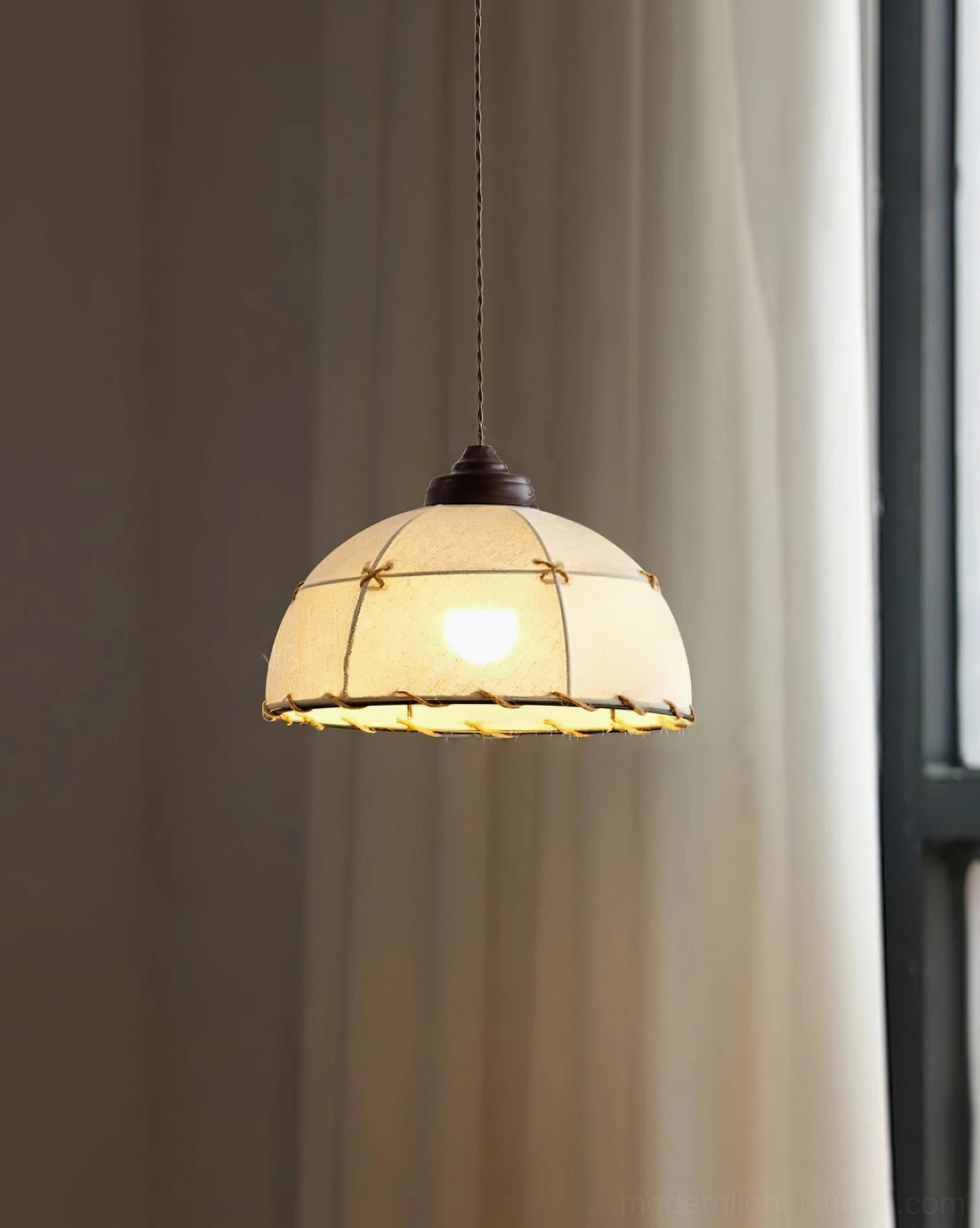 Artisan pendant light with soft warm natural light through fabric shade, subtle beige canvas illumination near dark window frame, minimalist interior aesthetic