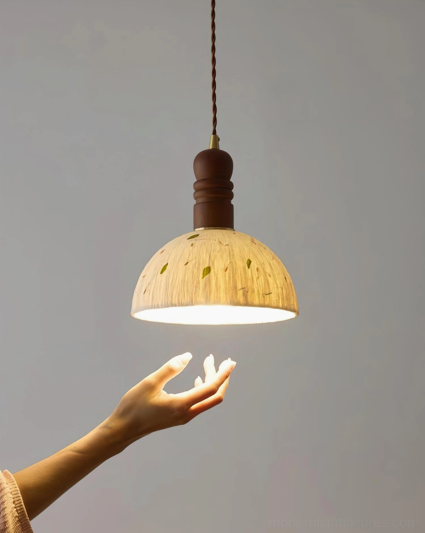 Dome pendant lamp creating soft diffused glow in minimalist modern living space with warm ambiance