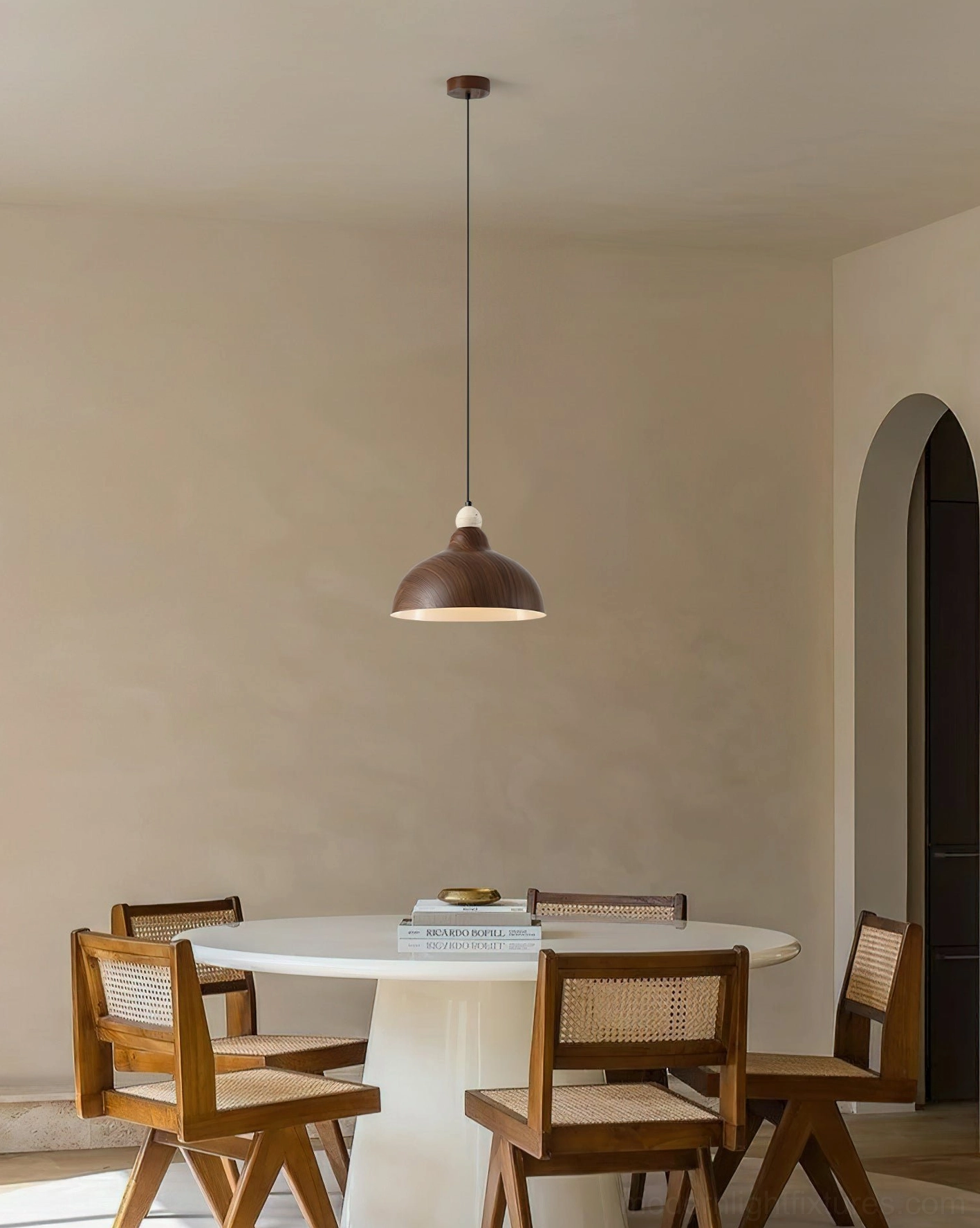 Walnut dome pendant light hanging over dining table in minimalist dining room setting