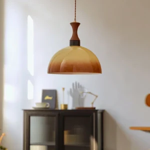 Dome pendant light with wooden top fixture and amber glass shade, oblique angle view in modern living room setting