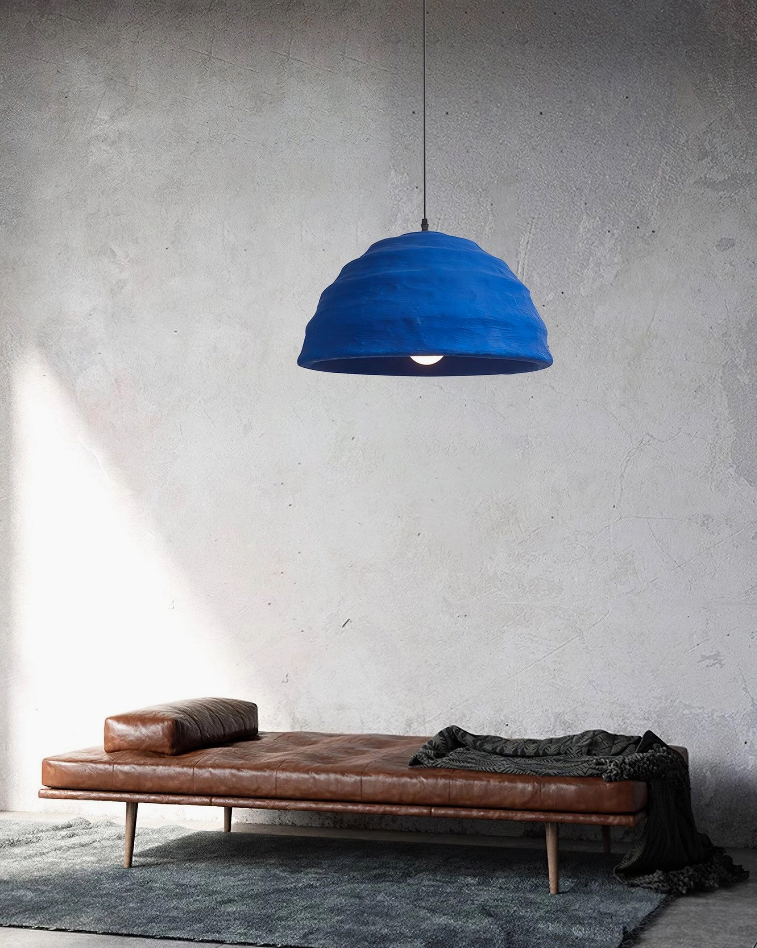 Dome pendant light suspended in interior space with natural light interaction and shadow play