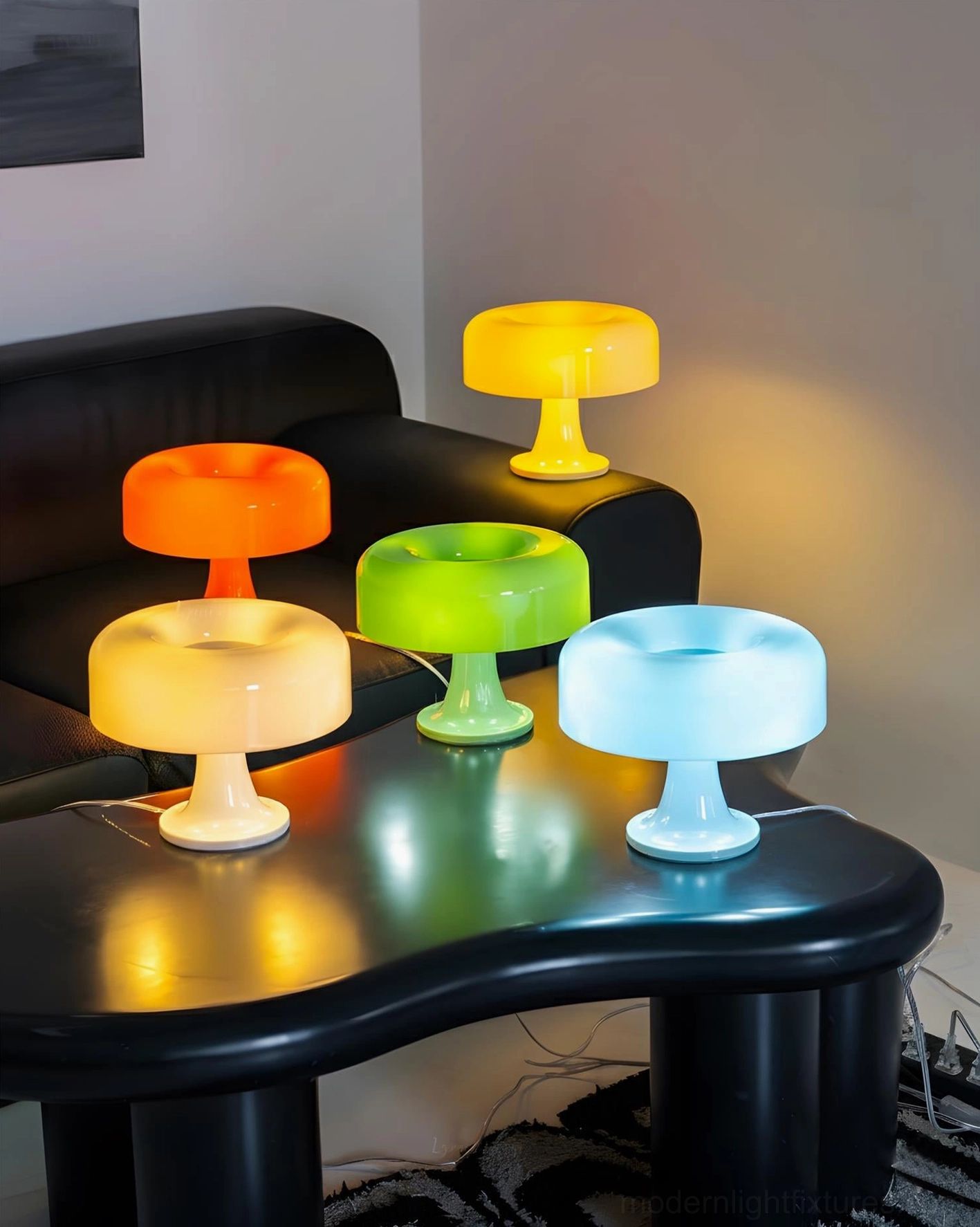 Assorted multicolor Donula table lamps in modern living room display with yellow, orange, cream, green, and blue