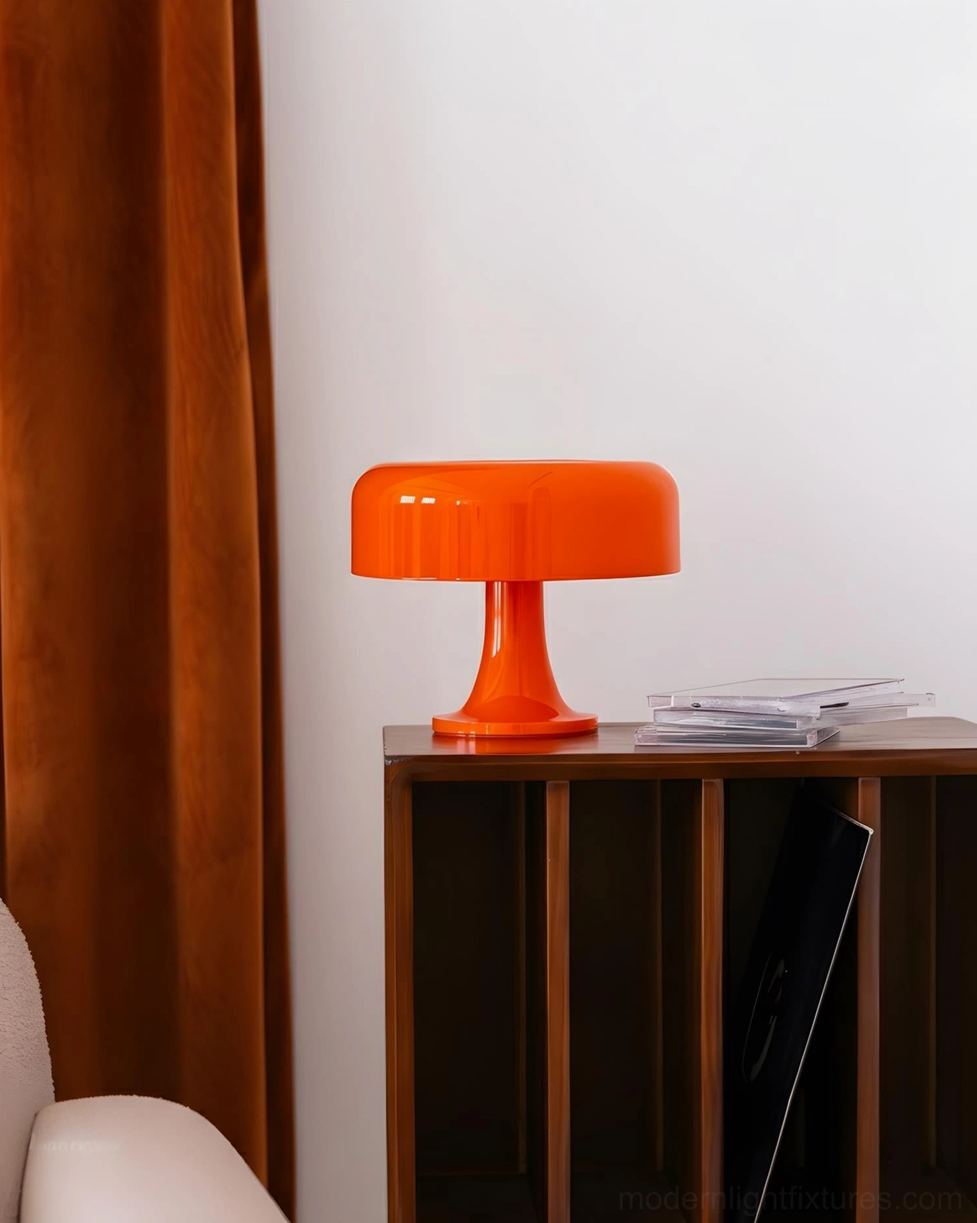 Orange Donula modern donut table lamp on wooden cabinet, mid-century minimalist style