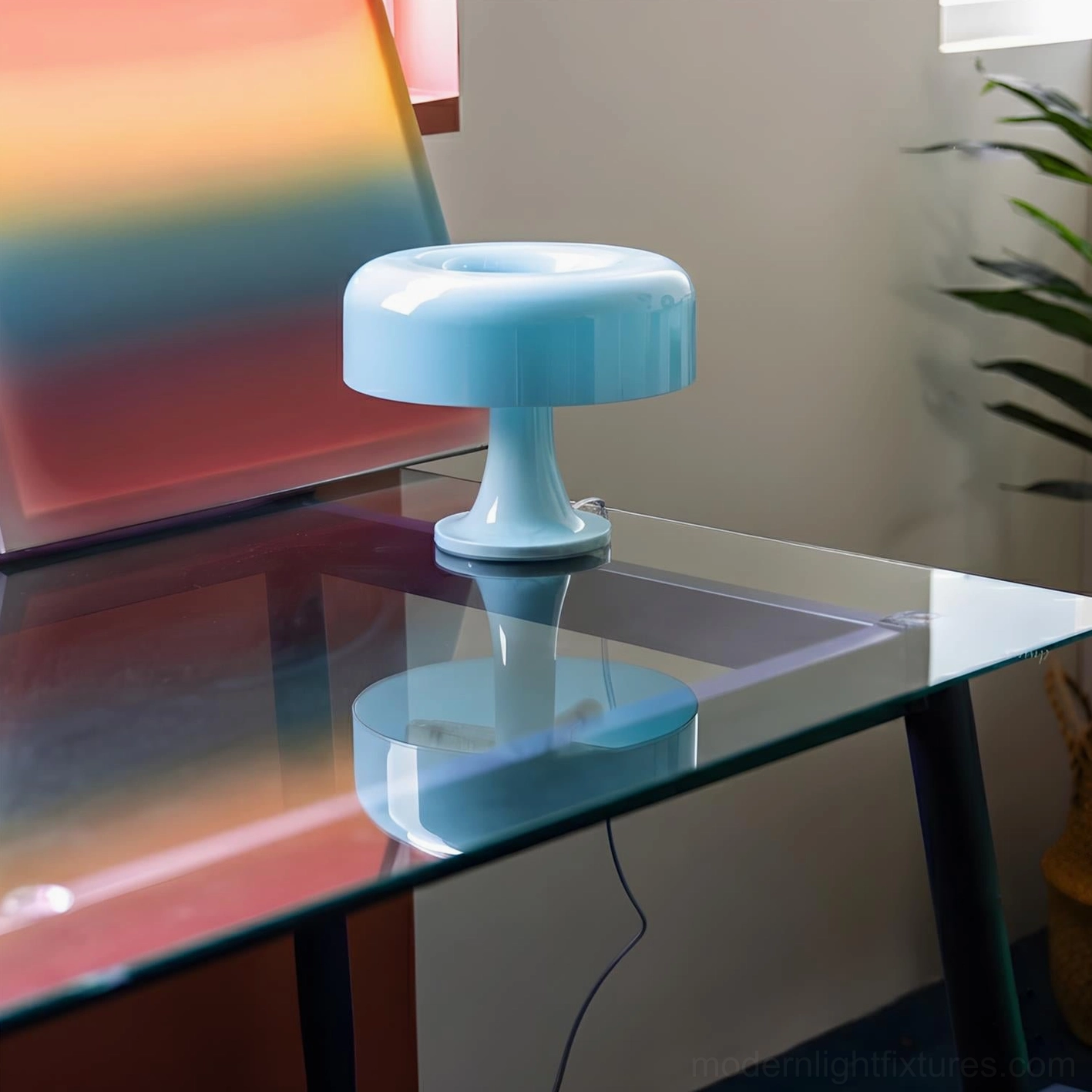 Sky blue Donula sculptural table lamp on glass table with indoor plant and modern backdrop