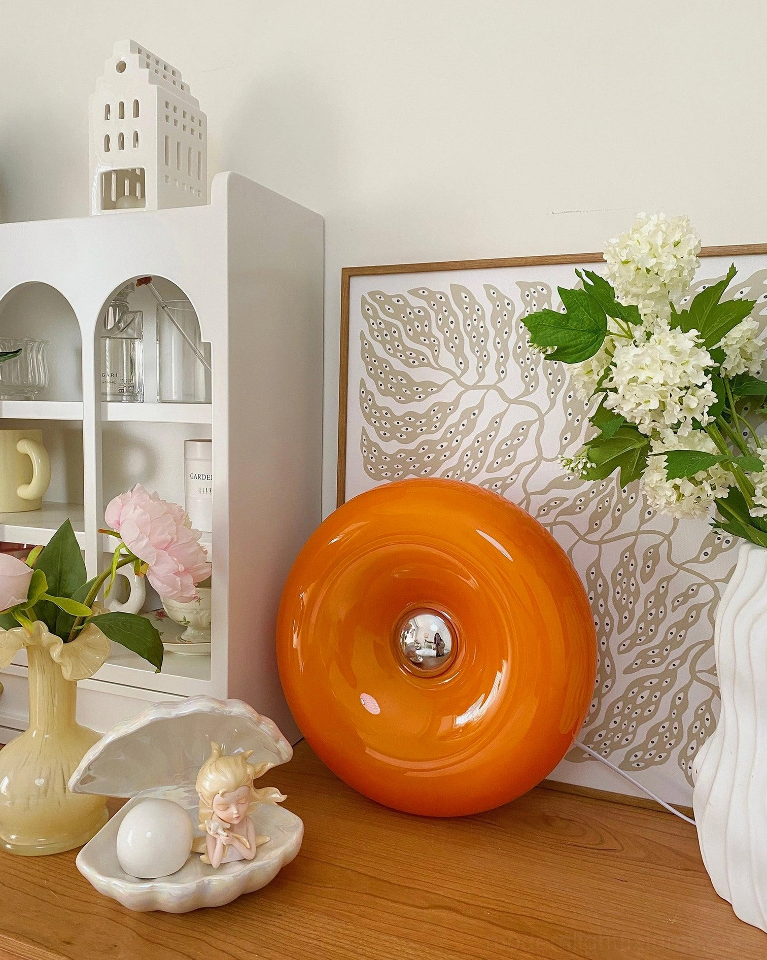 Orange donut table lamp with polished metal hardware details mid-century modern design
