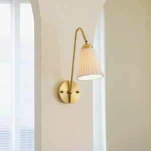 Dorelia wall sconce mounted side view in contemporary bedroom with arched window and warm ambient lighting