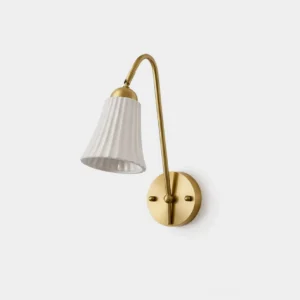 Dorelia brass wall sconce front view studio product photography with pleated white ceramic shade