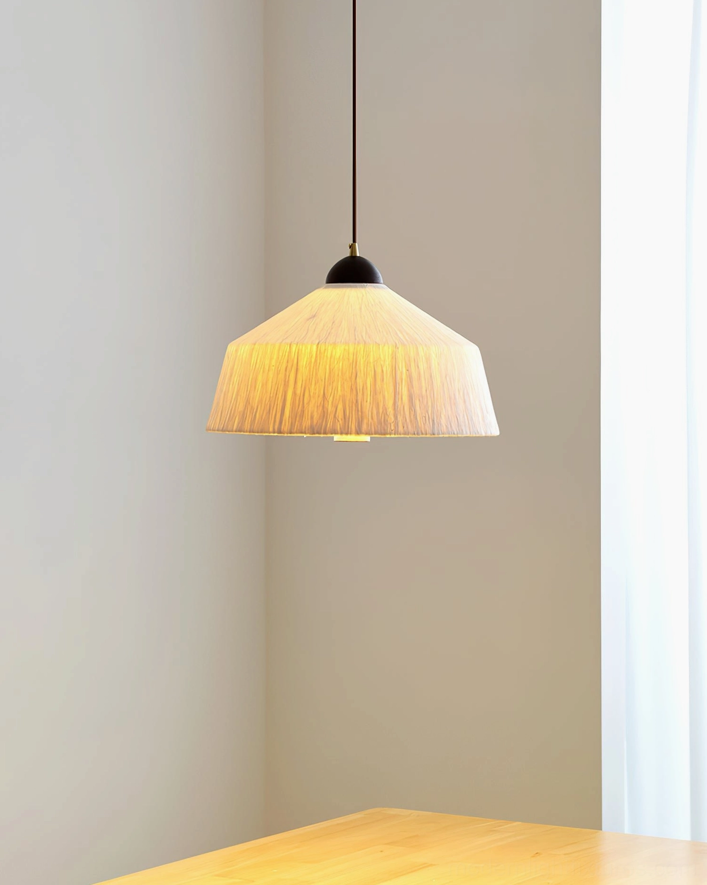Side view of pleated rice paper Doria pendant light in minimalist dining corner, warm glow from LED