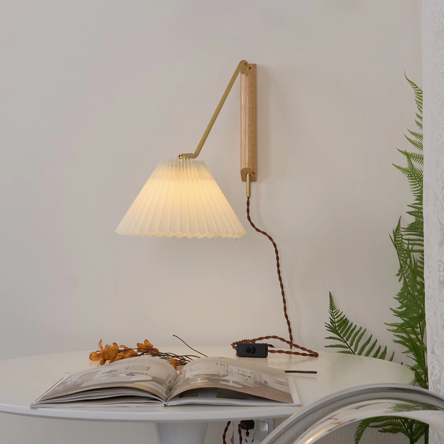 Dorset adjustable wall lamp by reading table showing three-quarter side view with light wood base