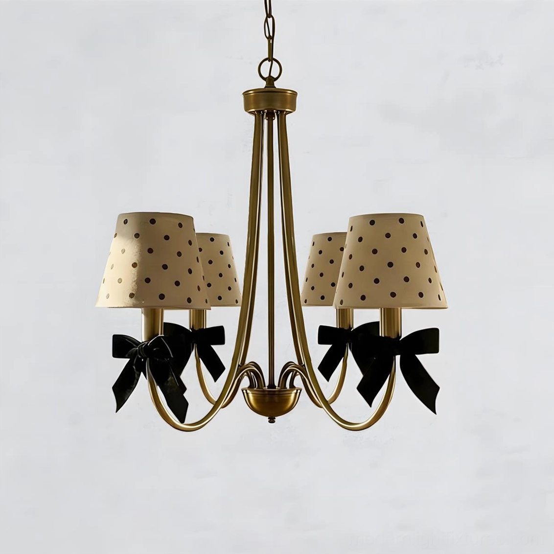 Close-up detail of polka dot shade, black velvet bow and brass metal structure