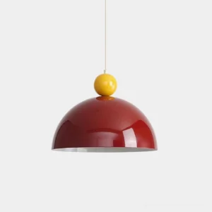 Dotto burgundy pop-art dome pendant lamp with yellow spherical accent, front studio view showcasing bold color-blocking design