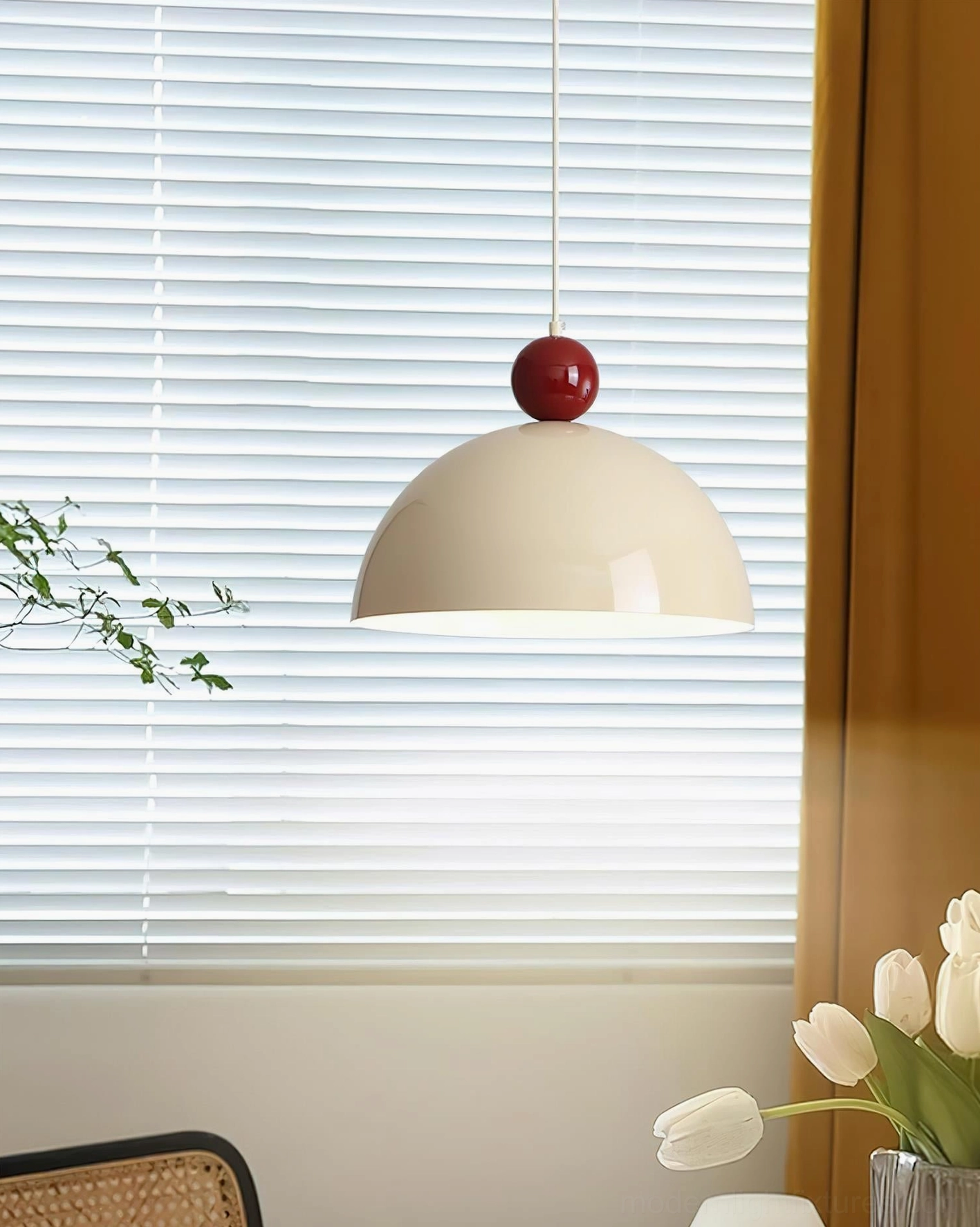 Dotto cream matte dome pendant lamp with red spherical top accent, side view in bright dining area with window treatments