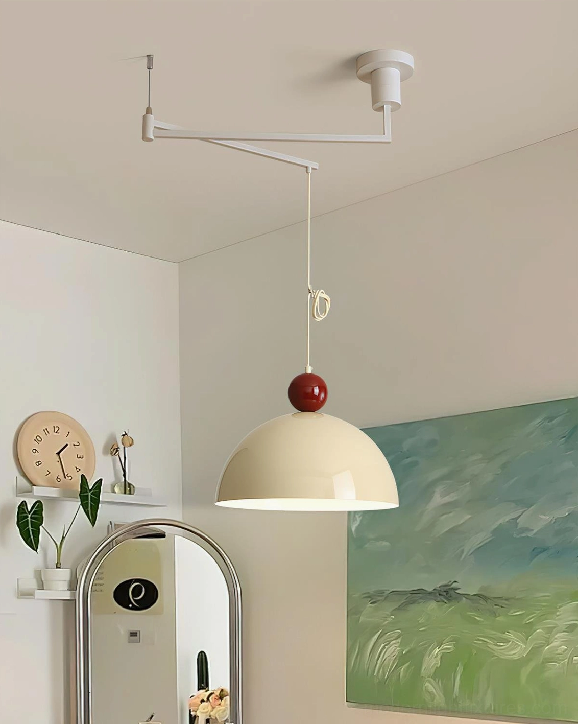 Green dome swing arm pendant light with dark red ball accent on white metal arm in home dining space