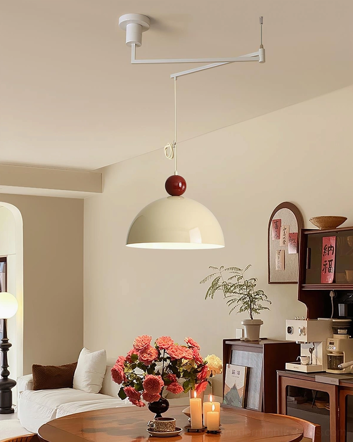 Green dome shade swing arm pendant with dark red spherical accent in retro residential living space