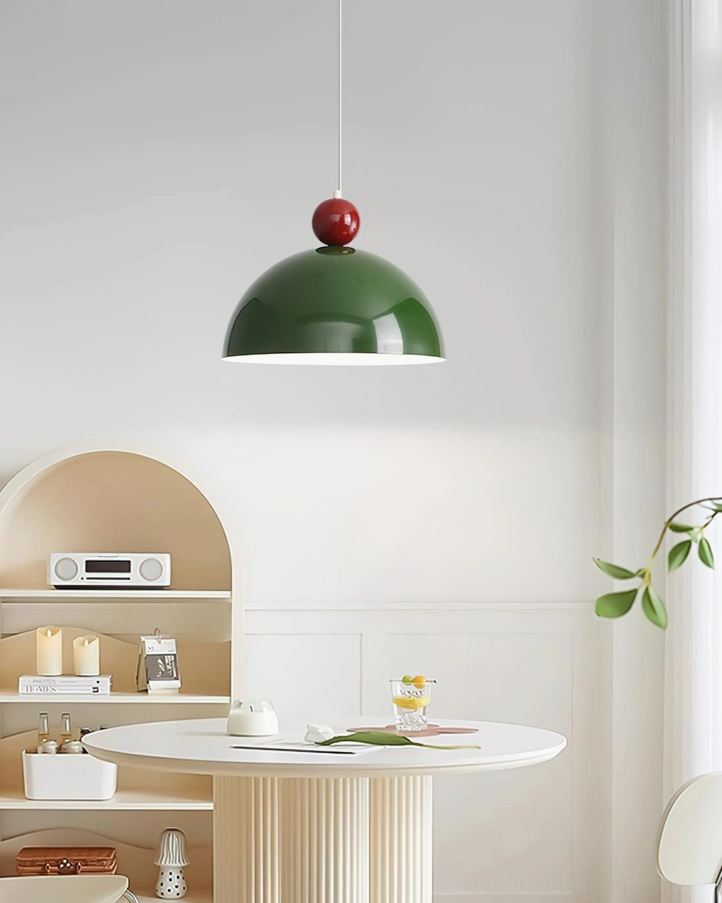 Dotto green dome pendant lamp with dark red spherical ball, side view in minimalist dining nook with glossy metal finish