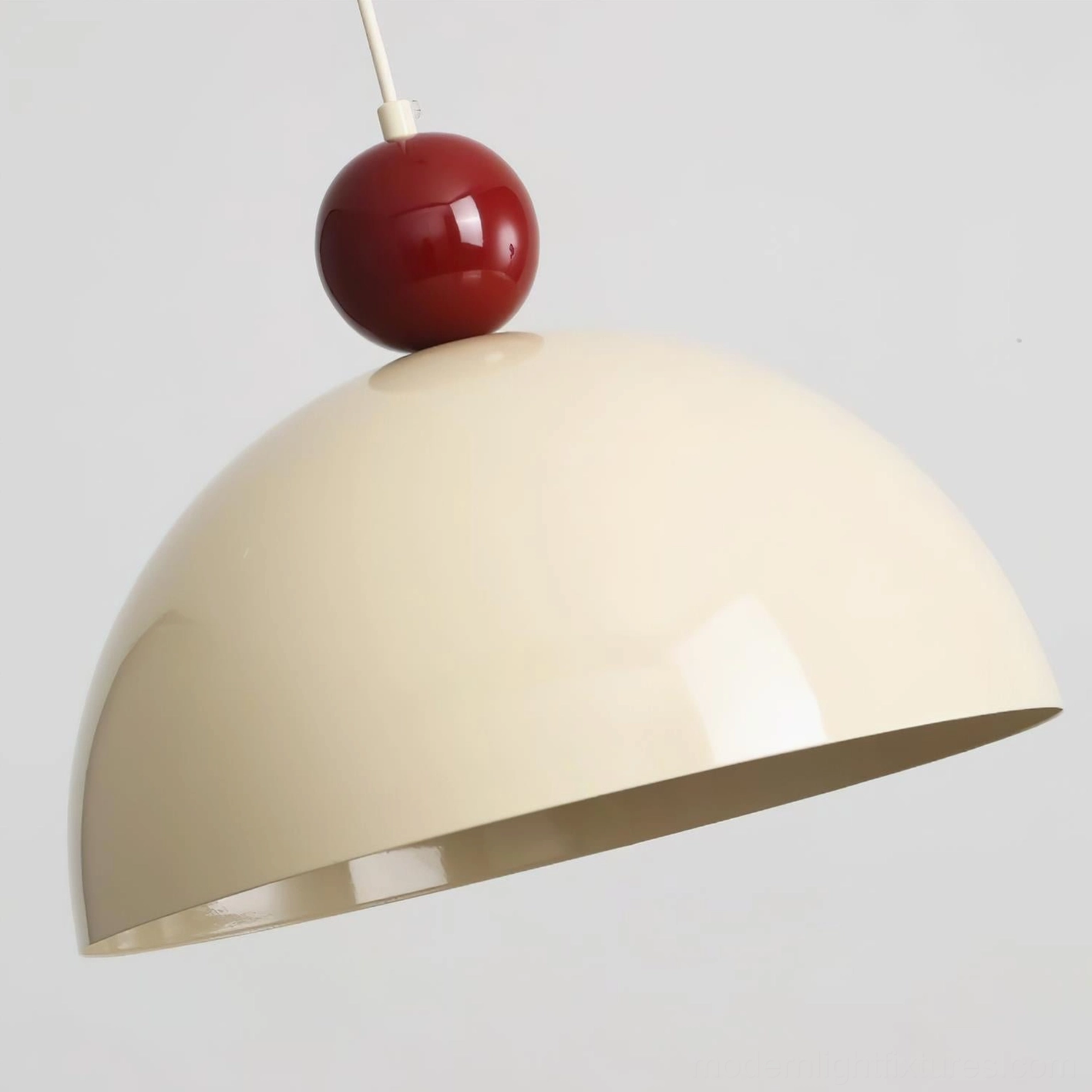 Close-up detail of Dotto swing arm pendant showing spherical accent and dome shade construction