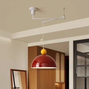 Modern swing arm pendant lamp in red with yellow top installed in residential dining area - low angle view