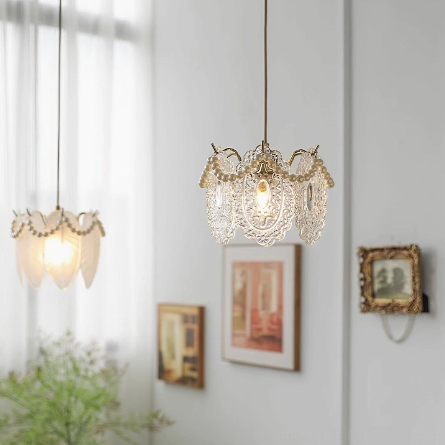 Twin crystal and frosted glass petal pendant lamps set displayed together in cozy home interior with wall decorations