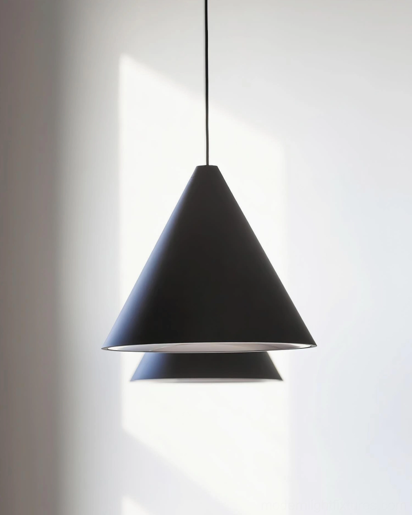 Double-layer industrial cone pendant light, matte black metal shade with exposed cable, minimalist decorative design detail