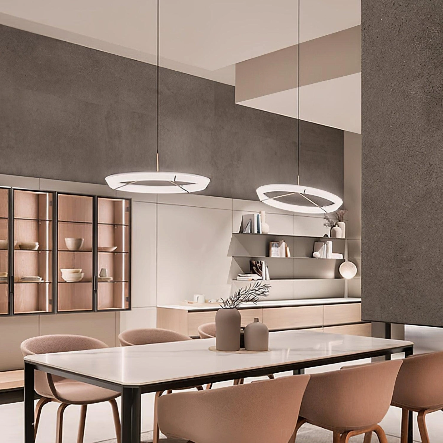 Dual matching round pendant lights in brass gold finish illuminating open concept kitchen dining space