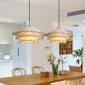 Two matching handwoven fabric pendant lights in warm dining space with wooden table, modern Japandi interior design