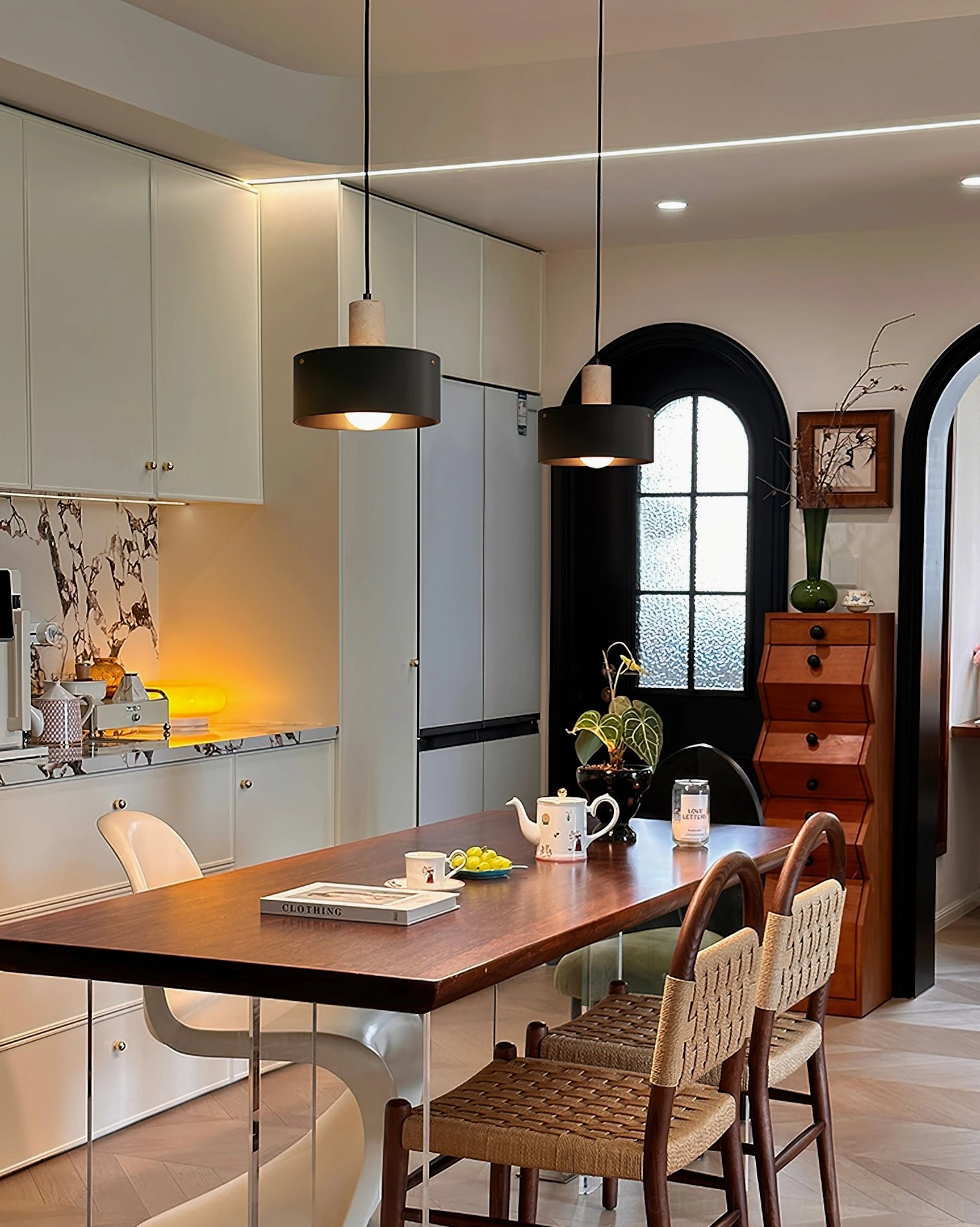 Mixed black and wooden Dovira drum pendant lights in open kitchen dining area with vintage family space, arched windows, and contemporary interior styling