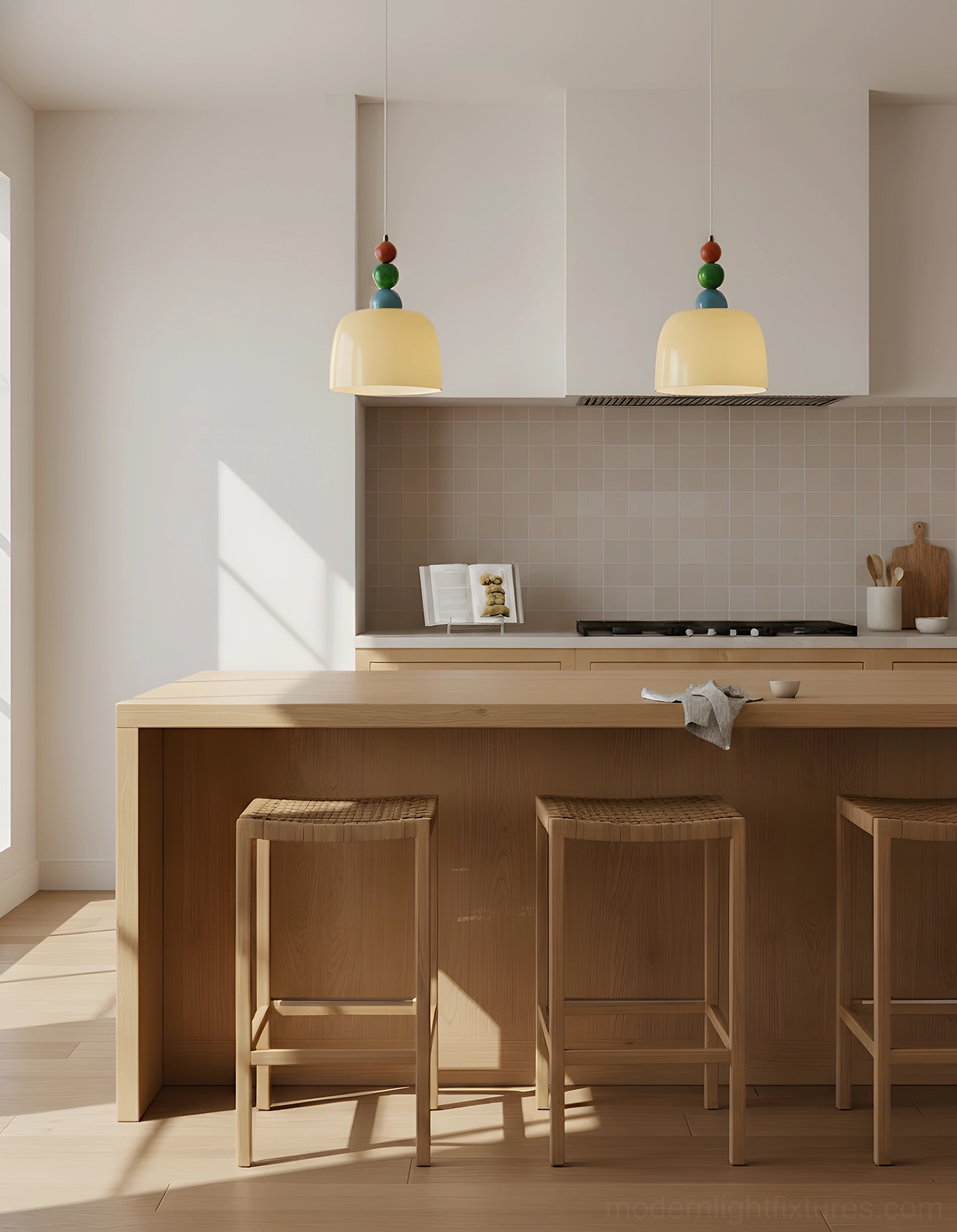 Pair of matching colorful beaded pendant lights suspended above kitchen island with wooden countertop