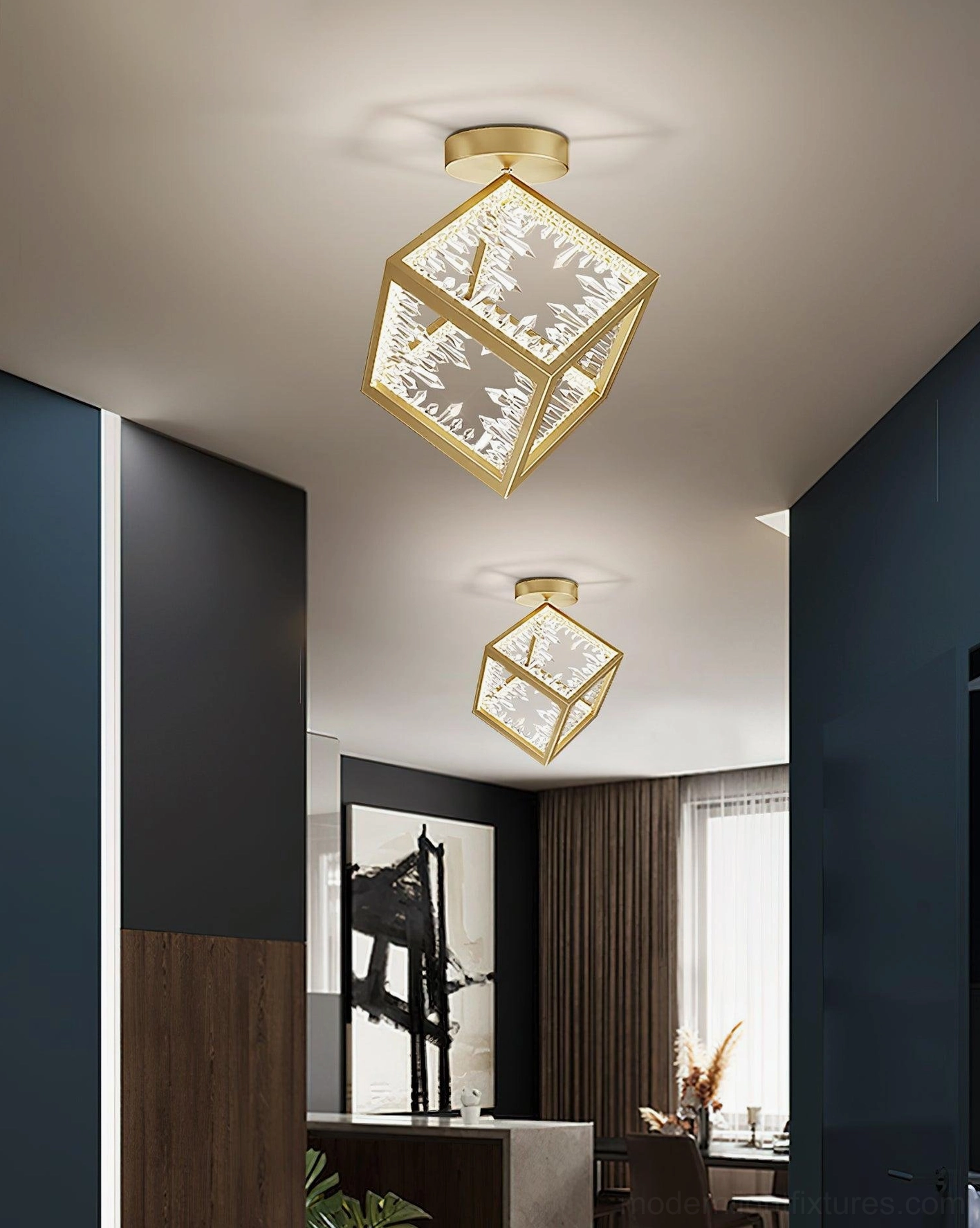Dual matching gold cubic ceiling lights in residential entryway and dining area