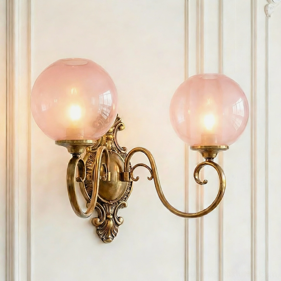 Dual-head ornate brass wall sconce with pink glass globes, romantic vintage baroque lamp