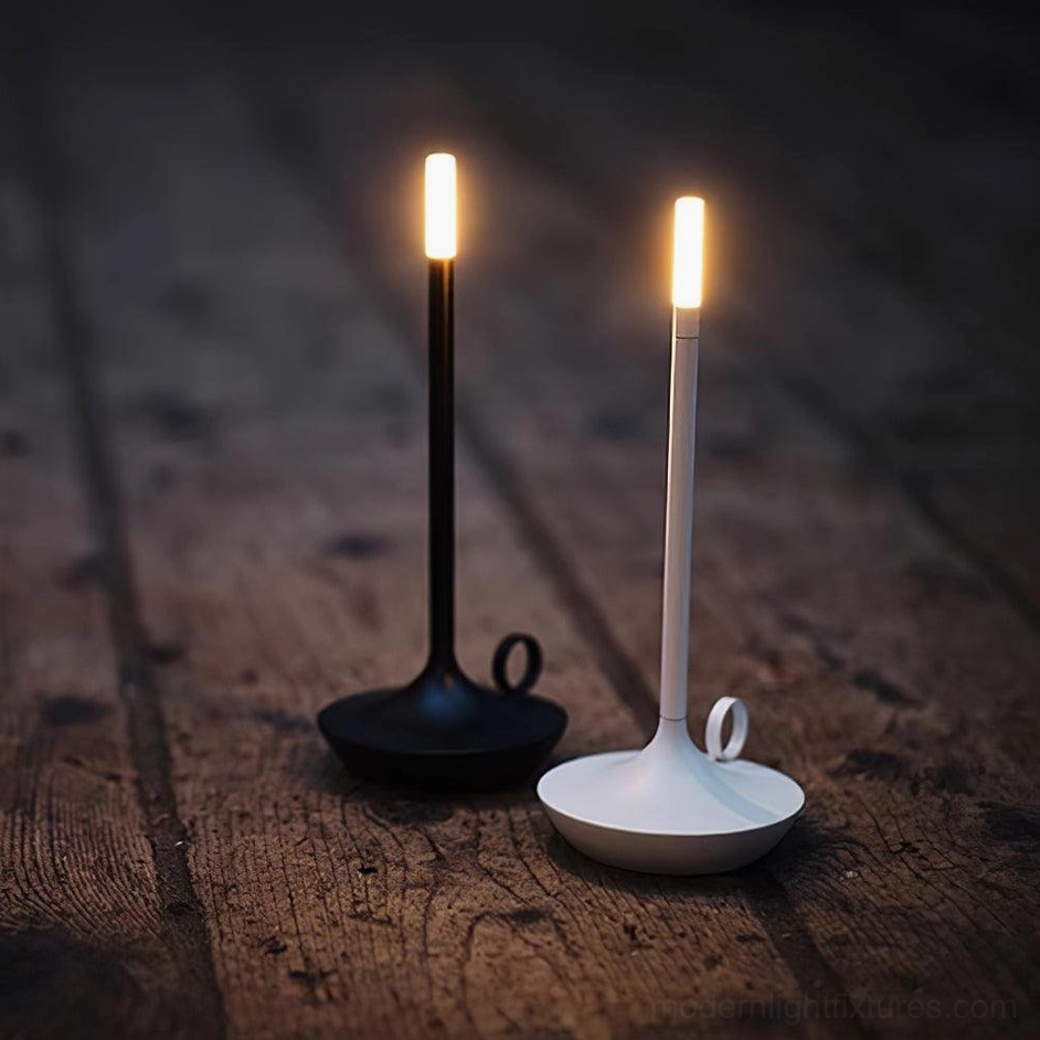 Dual minimalist LED candle table lamps creating symmetrical warm bedside ambiance in contemporary bedroom setting