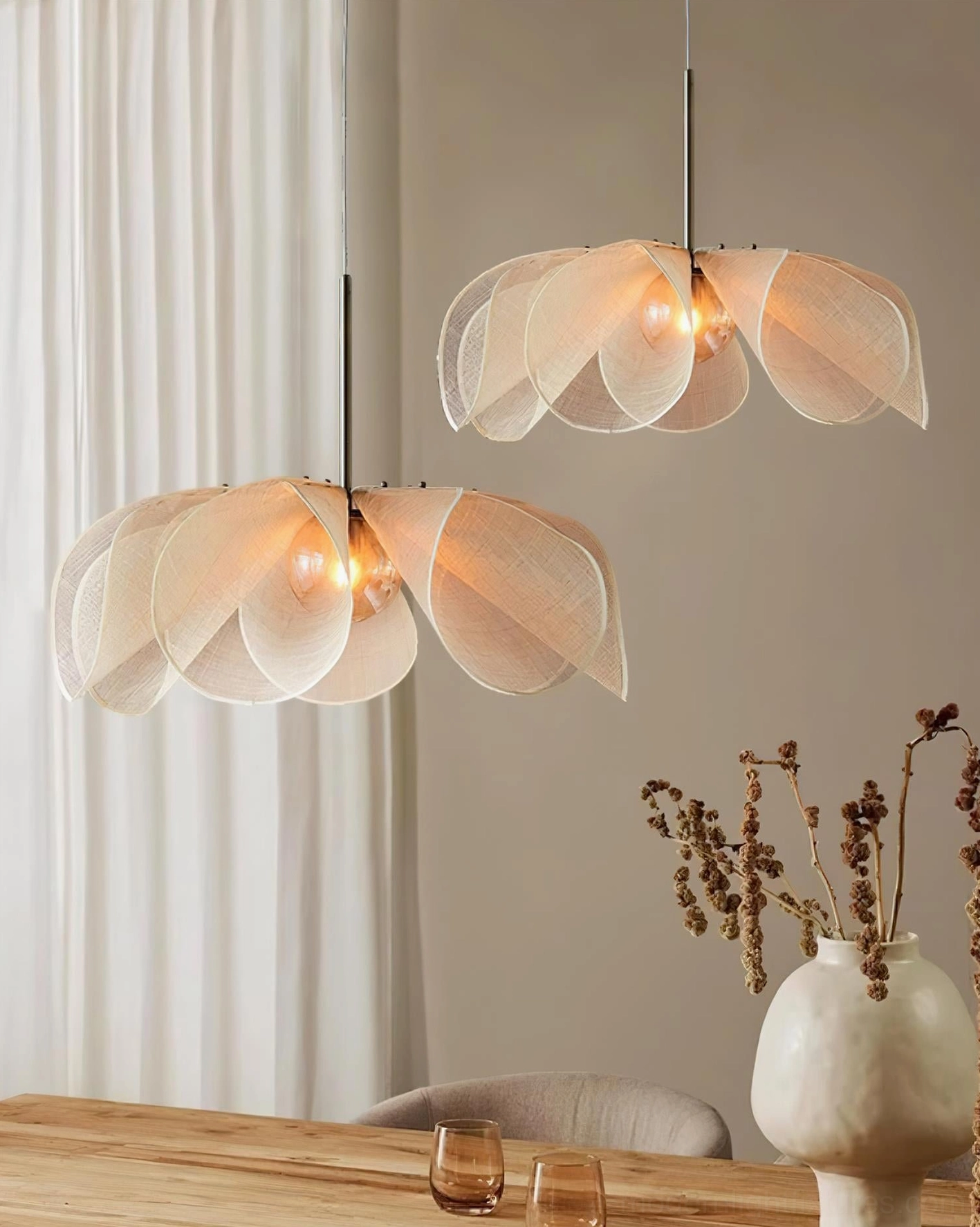 Dual Styria Petals petal pendant lights above wooden dining table with dried florals in wabi-sabi rustic minimalist interior