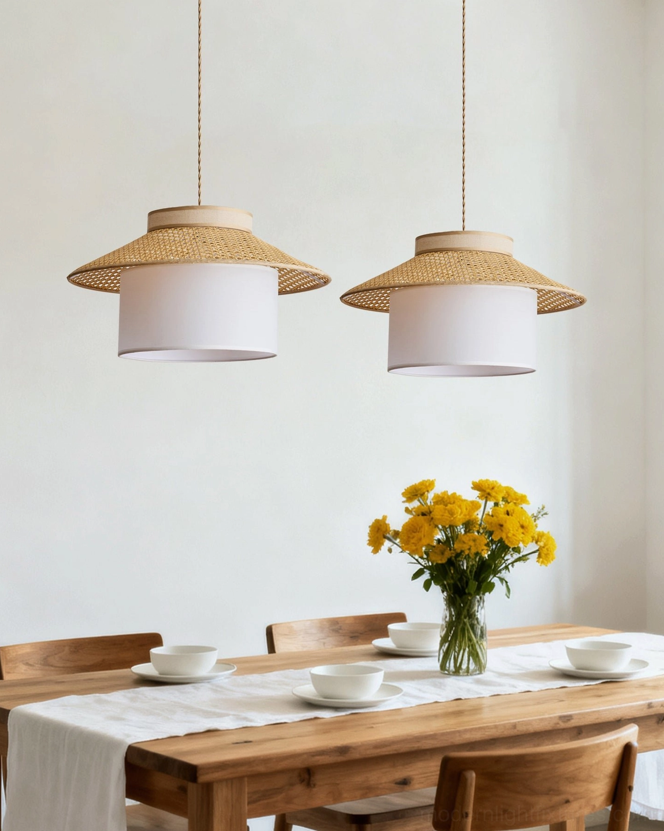 Dual rattan pendant lights in family dining space with boho rustic style, coordinated hanging lamp design
