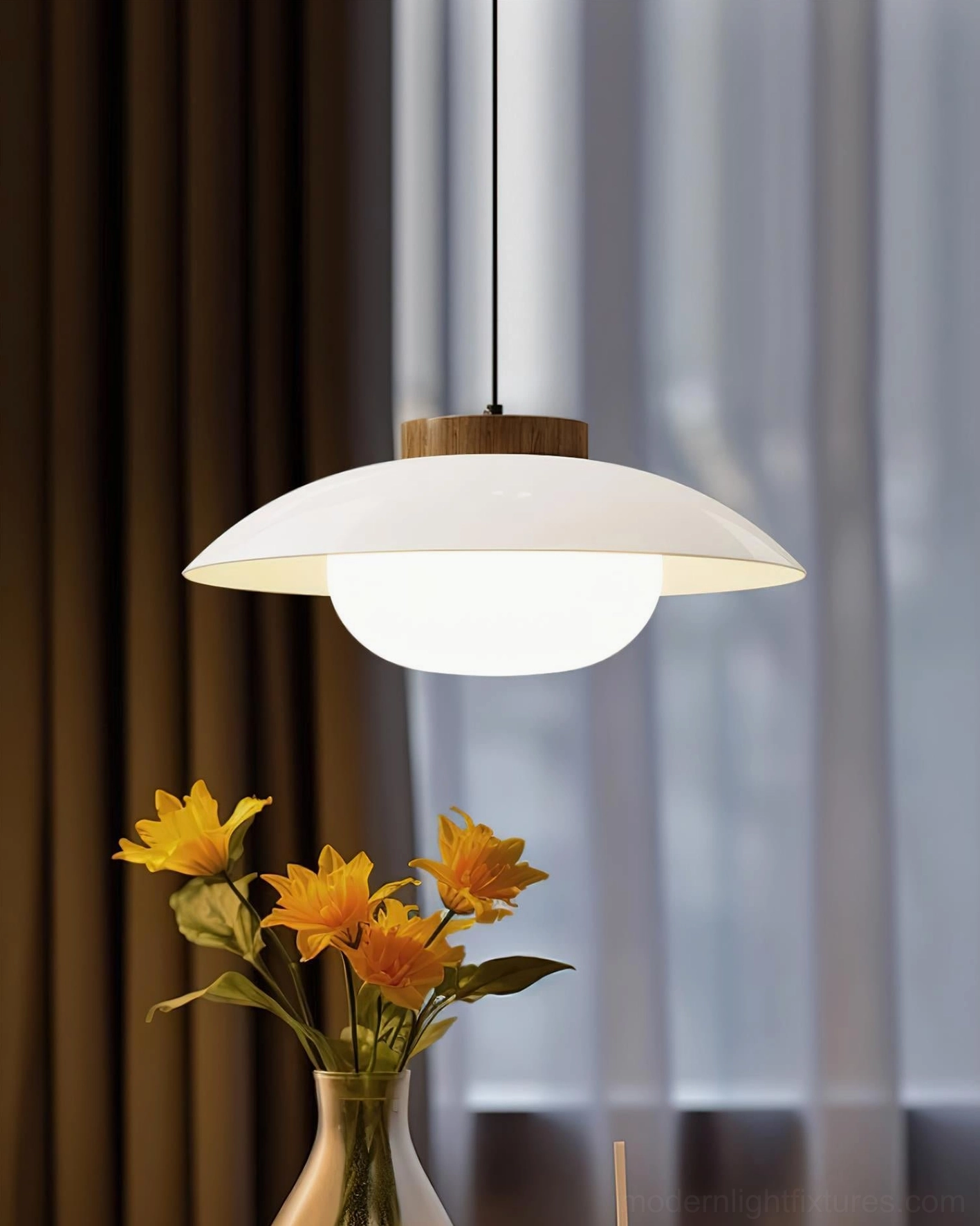 Matching pair of sage green modern pendant lights suspended above kitchen island, twin Sima fixtures in contemporary minimalist kitchen