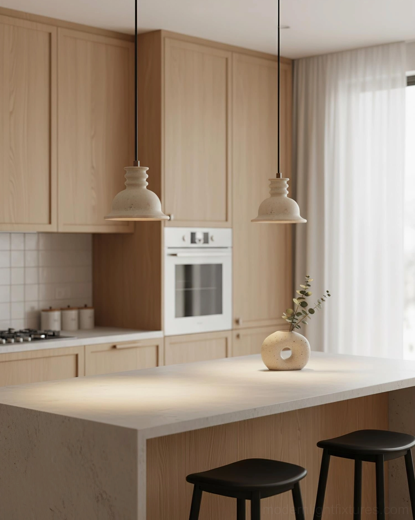 Dual travertine pendant lights suspended over warm wood-toned kitchen island with soft ambient lighting in minimalist interior