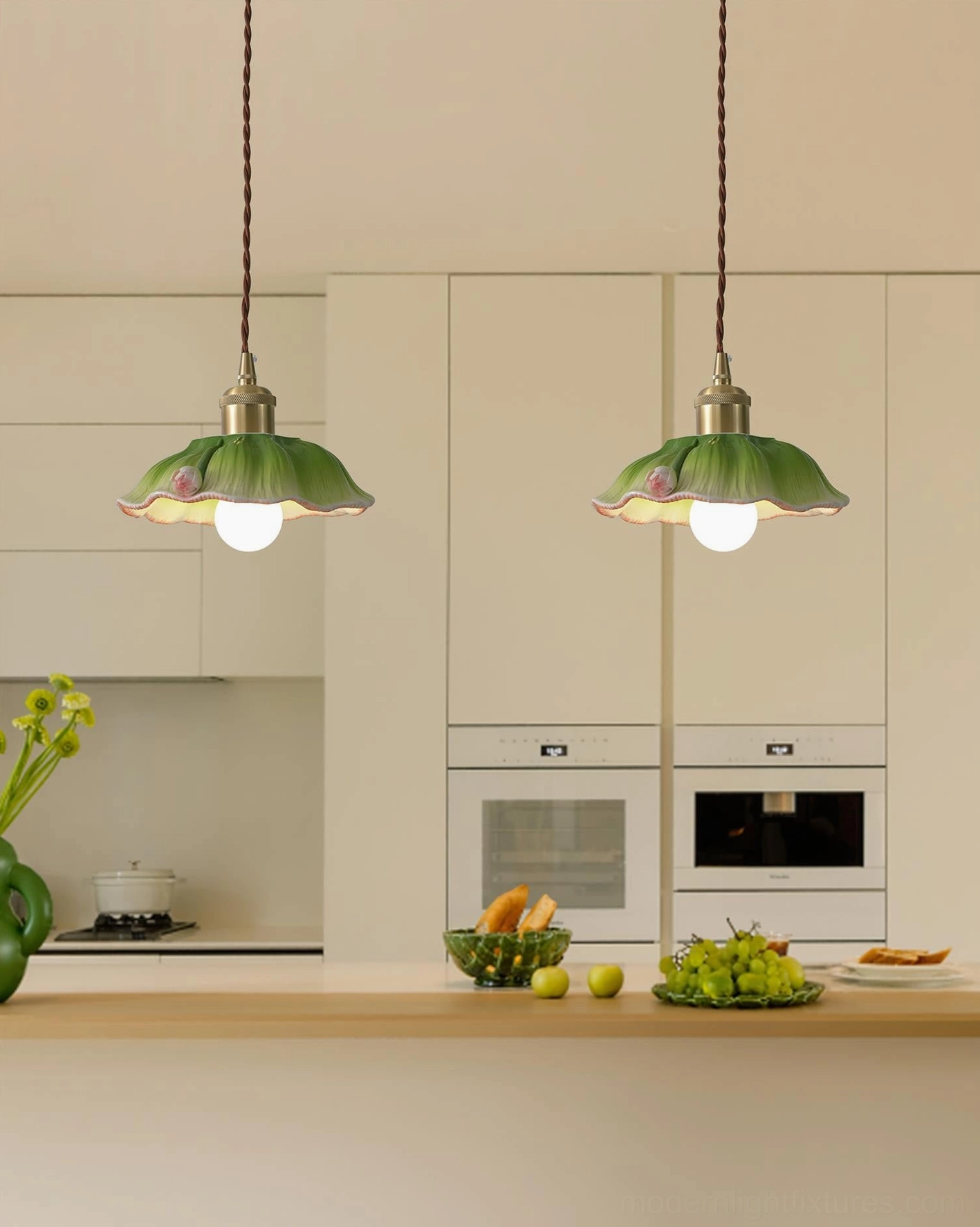 Twin verdant lotus pendant lights installed in modern residential kitchen, warm ambient lighting over counter seating