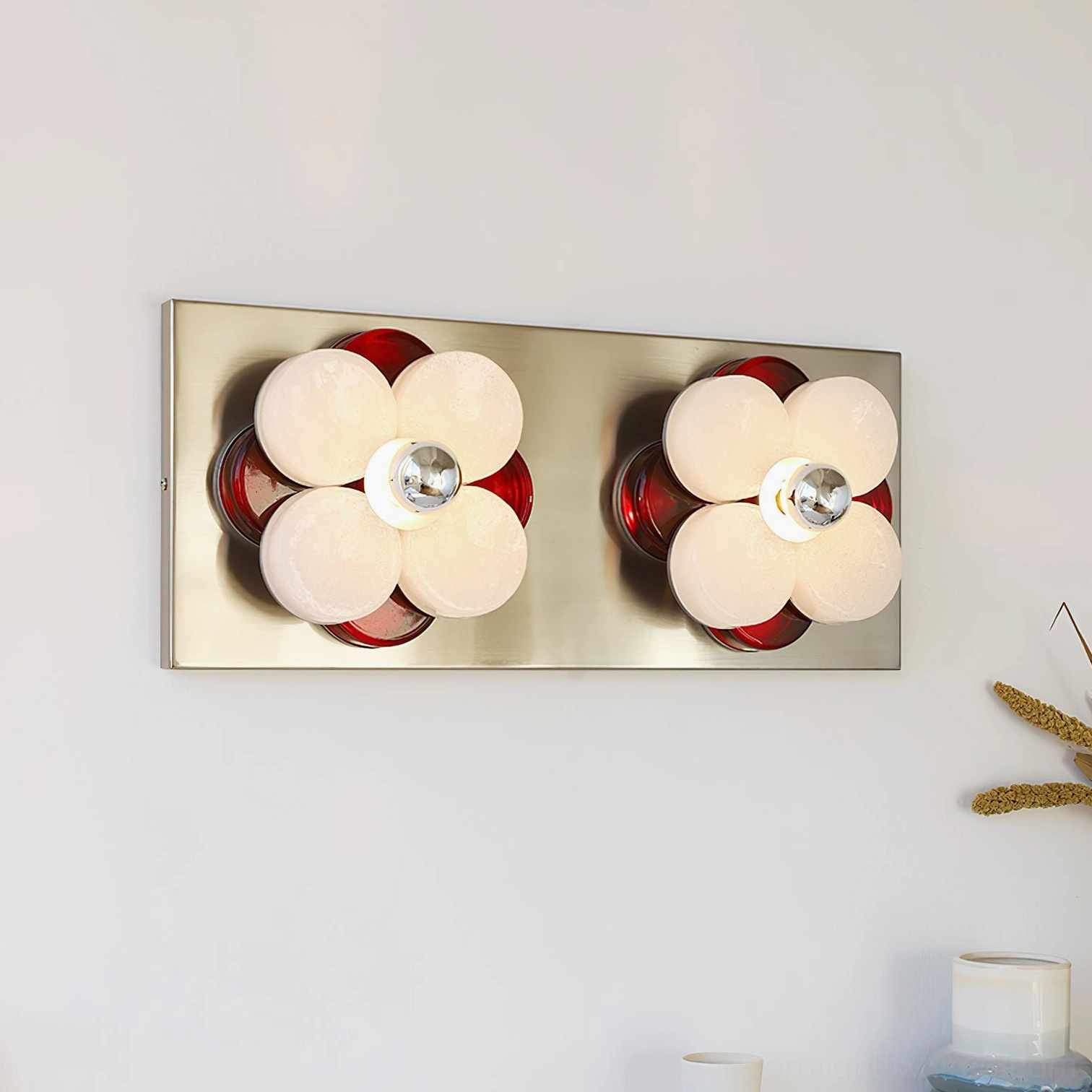 Pair of Violetta flower wall sconces with long silver base plate, red backing accents, white petal design in modern retro style